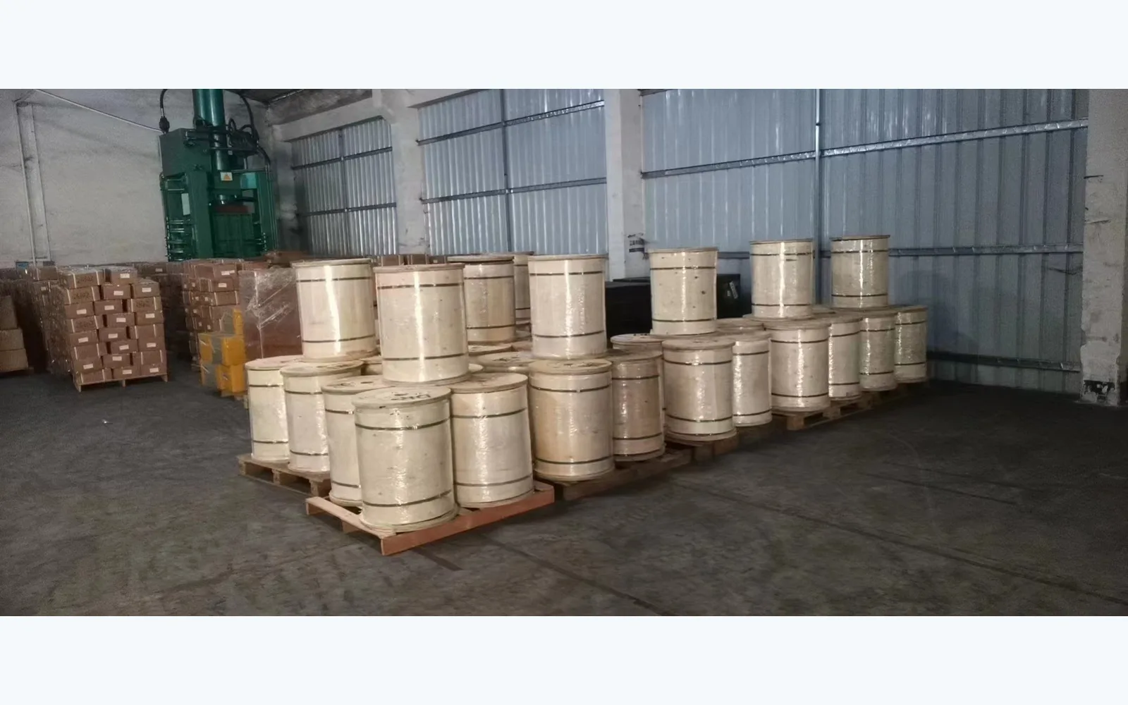 Finished cable drums in the factory warehouse, used to illustrate project material preparation before an approved ADSS stringing plan